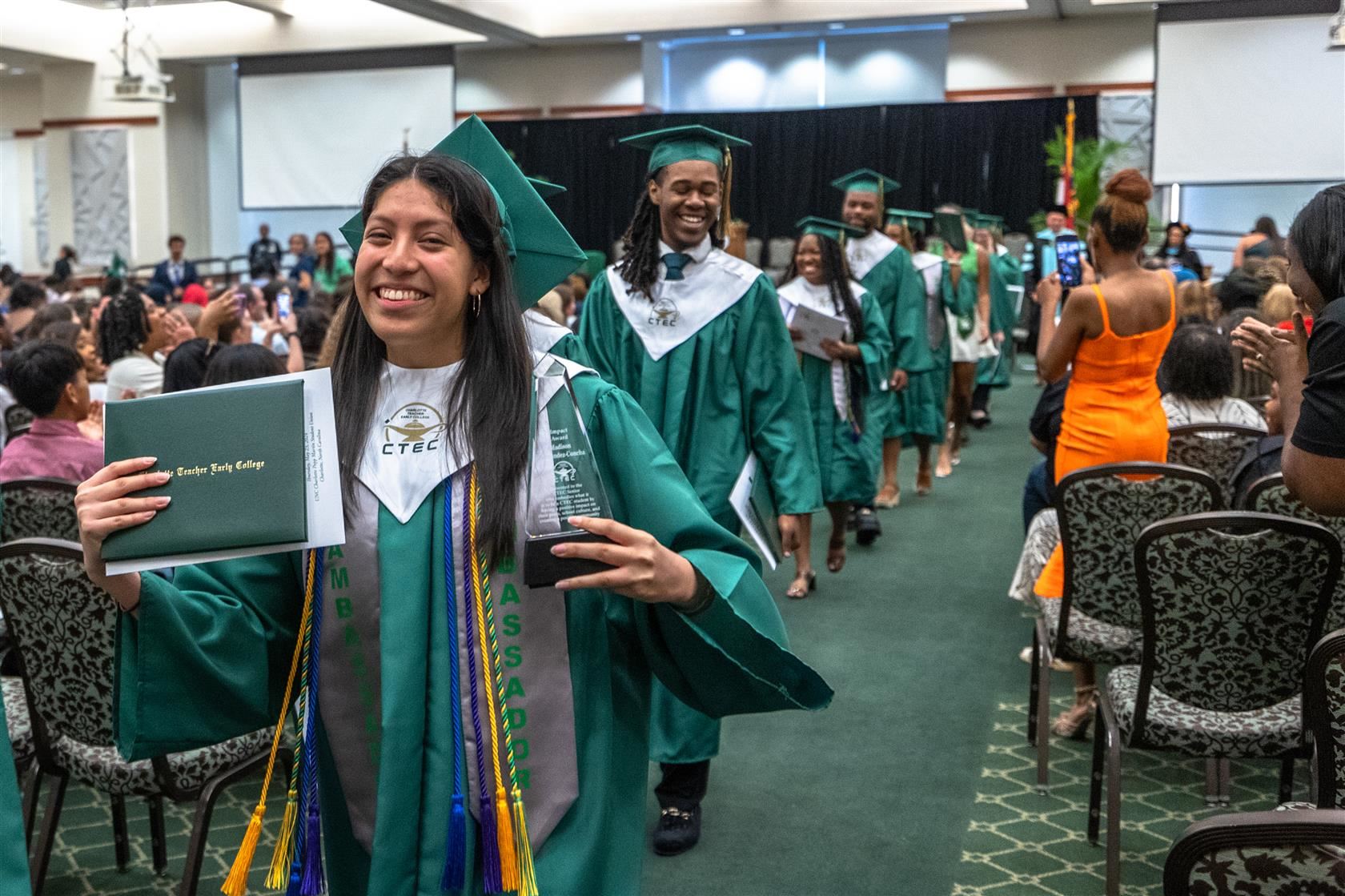 Goal 4 - The Postsecondary Readiness | Image of CMS graduate smiling in their cap and gown